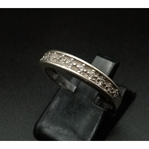 566 - A 9K White Gold Diamond Half Eternity Ring. 0.10ct. 
Size O. 2g