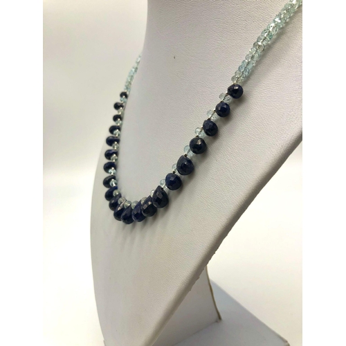 599 - A 125ct Aquamarine and Blue Sapphires Necklace. 42cm in length.