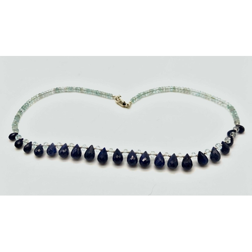 599 - A 125ct Aquamarine and Blue Sapphires Necklace. 42cm in length.