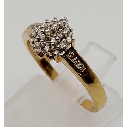 114 - A 9 K yellow ring with a cluster of diamonds. Ring size: N, weight: 2.11 g.