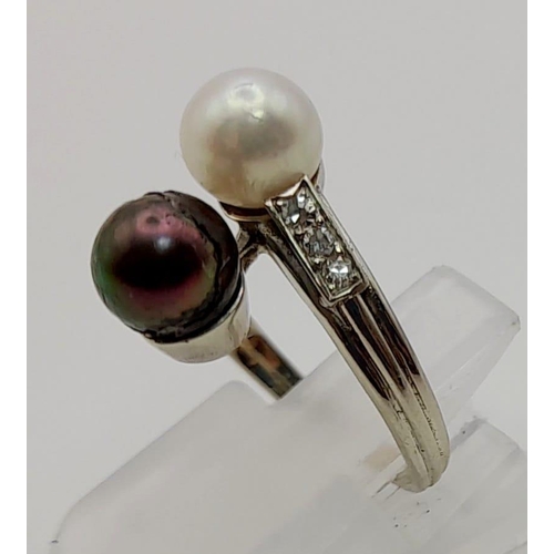 142 - An 18 K white gold ring with two Tahitian pearls (one black, one white) and diamonds on the shoulder... 