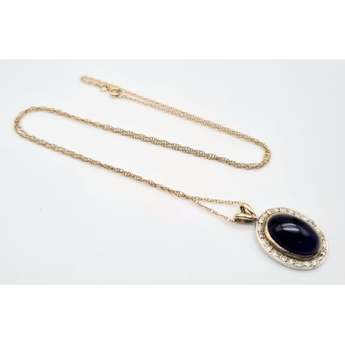 438 - A 9K GOLD PENDANT WITH A LARGE AMETHYST CABOCHON CENTRE STONE ON A 48cms 9K GOLD CHAIN.4.17gms