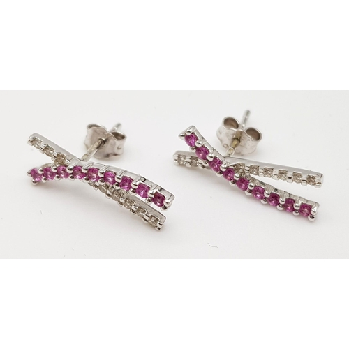 440 - A PAIR OF 18K WHITE GOLD EARRINGS WITH DIAMONDS AND PINK RUBIES.  2.4gms