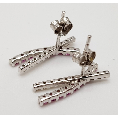 440 - A PAIR OF 18K WHITE GOLD EARRINGS WITH DIAMONDS AND PINK RUBIES.  2.4gms