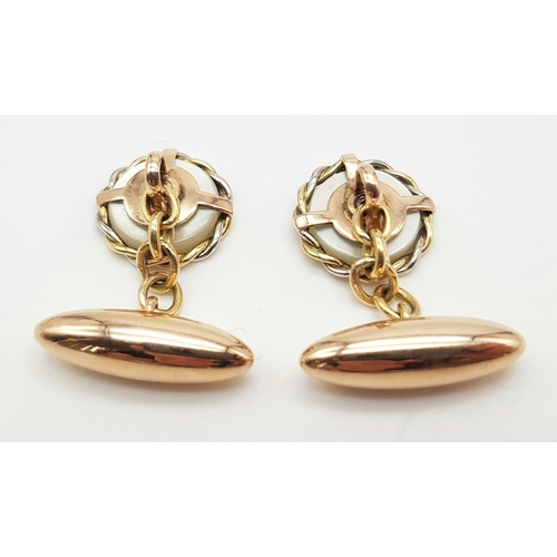 451 - A PAIR OF VICTORIAN 10K ROSE GOLD CUFFLINKS WITH MOTHER OF PEARL AND RUBY CENTRE STONE.   6.7gms