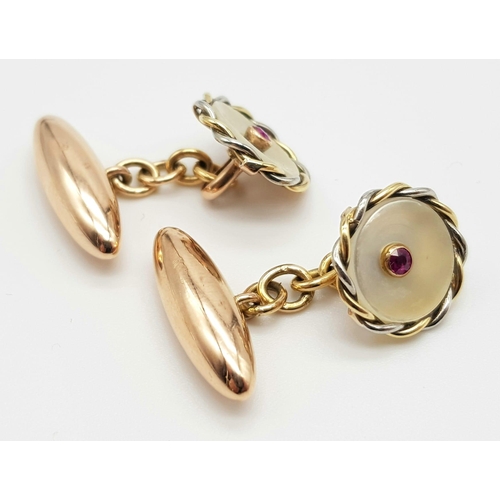 451 - A PAIR OF VICTORIAN 10K ROSE GOLD CUFFLINKS WITH MOTHER OF PEARL AND RUBY CENTRE STONE.   6.7gms