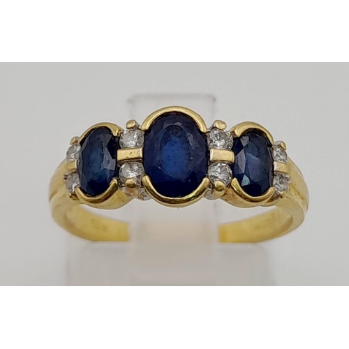 67 - An 18 K yellow gold ring with blue sapphires and diamonds. Ring size: K, weight: 3.03 g.