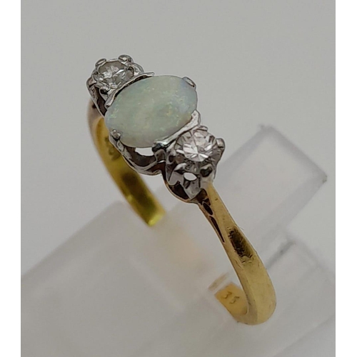 81 - An 18 K yellow gold ring with an opal cabochon and two brilliant cut diamonds. Ring size: L, weight:... 