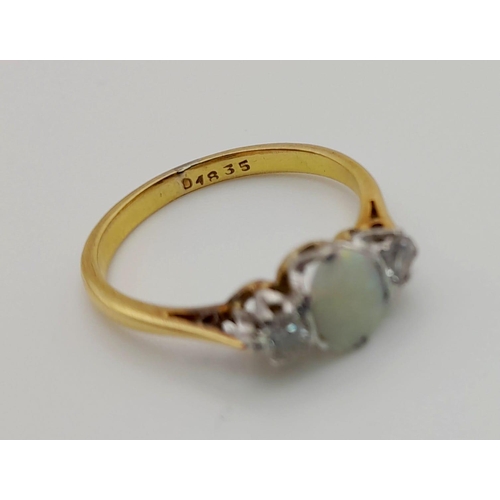 81 - An 18 K yellow gold ring with an opal cabochon and two brilliant cut diamonds. Ring size: L, weight:... 