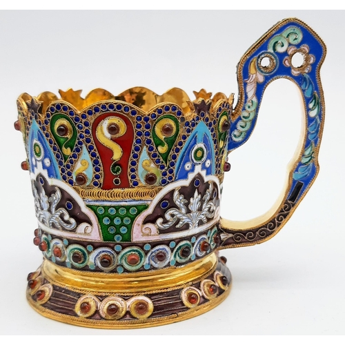 219 - An Unusual Russian Silver and Cloisonné Enamel Tea Glass Cup Holder. Gem-set decoration with a richl... 