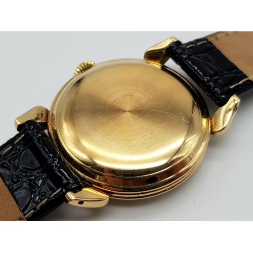 14 - 14K YELLOW GOLD MOVADO WATCH, CIRCULAR FACE GOLD DIAL 32MM, MANUAL WIND AND BLACK STRAP