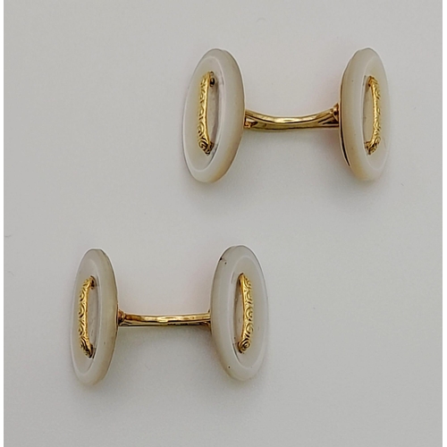 466 - A PAIR OF MOTHER OF PEARL CUFF LINKS SET IN 14K GOLD.  7.3gms