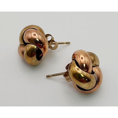 410 - A PAIR OF YELLOW AND ROSE GOLD EARRINGS  IN A KNOT SHAPE,   2gms