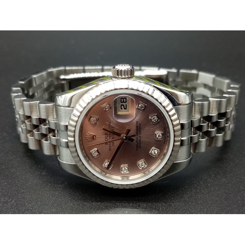 82 - A ladies ROLEX Oyster Perpetual Datejust, stainless steel watch. 26 mm dial, pink face with diamond ... 