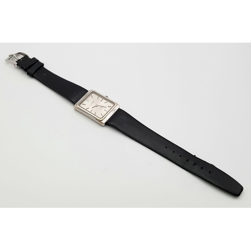 21 - TUDOR STEEL GENTS QUARTZ WATCH, RECTANGULAR FACE AND BLACK LEATHER STRAP, 24X32MM