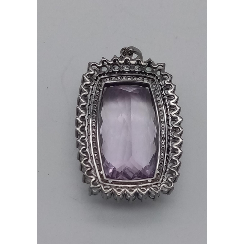 312 - A very large 54cts Amethyst Gemstone with 3.80cts Aquamarine Gemstones and 0.85cts Diamonds surround... 