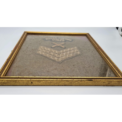 569 - Framed WW1 Royal Flying Corps Sgts insignia cut from a tunic sleeve.