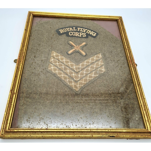 569 - Framed WW1 Royal Flying Corps Sgts insignia cut from a tunic sleeve.