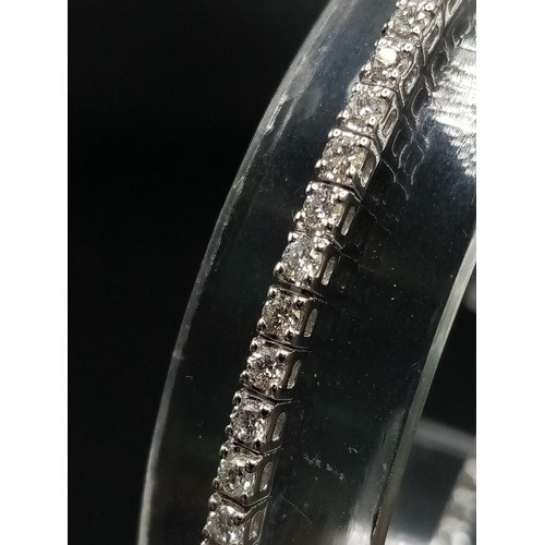 473 - AN 18K WHITE GOLD AND 3CT DIAMOND TENNIS BRACELET.  7.4gms