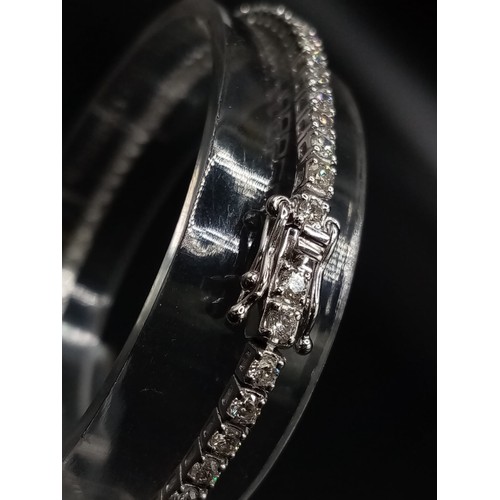 473 - AN 18K WHITE GOLD AND 3CT DIAMOND TENNIS BRACELET.  7.4gms