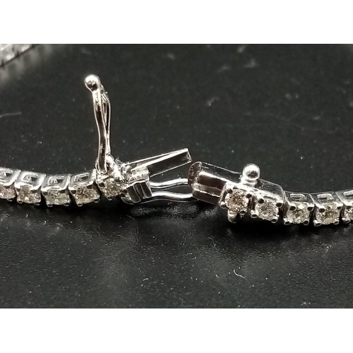 473 - AN 18K WHITE GOLD AND 3CT DIAMOND TENNIS BRACELET.  7.4gms