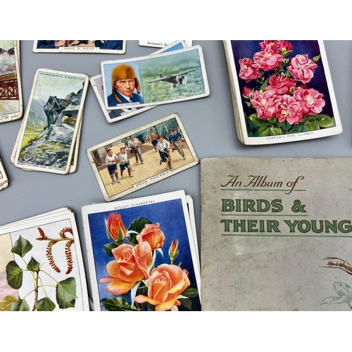 974 - A Collection of Over 100 Vintage and Antique Cigarette 
Cards.