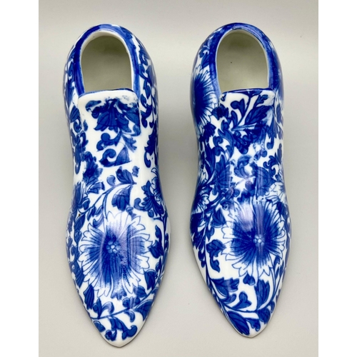 896 - A Pair of Vintage Blue and White Porcelain Shoes. 18 x 10cm. In good condition but A/F.