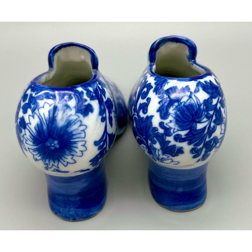 896 - A Pair of Vintage Blue and White Porcelain Shoes. 18 x 10cm. In good condition but A/F.