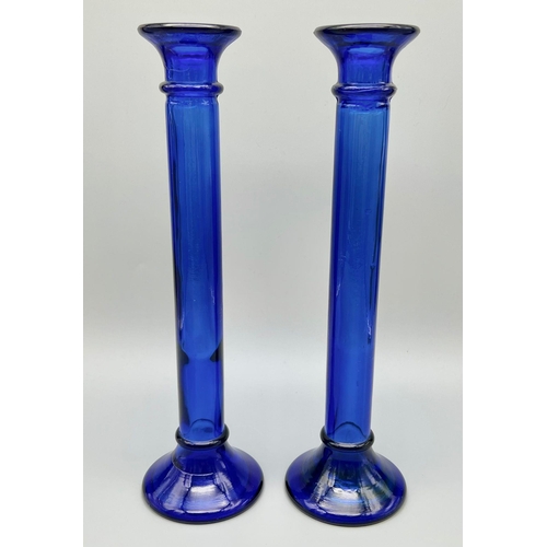 982 - A Pair of Cobalt Blue Glass Candlesticks. 28cm tall. In good condition but A/F.