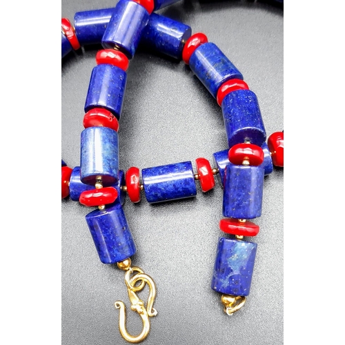 113 - A substantial lapis lazuli and red coral necklace and earrings set in a presentation box. Necklace l... 