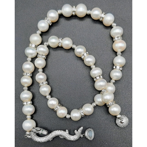 127 - A high quality, Chinese, large pearl necklace with a dragon clasp accompanied by matching earrings. ... 