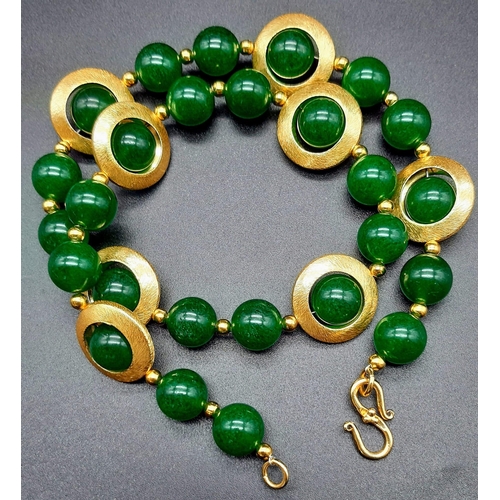 141 - A 60’s style green jade with gilded accents necklace and earrings set in a presentation box. Necklac... 