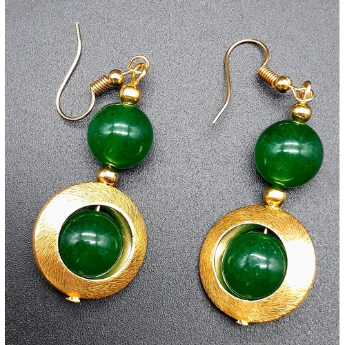 141 - A 60’s style green jade with gilded accents necklace and earrings set in a presentation box. Necklac... 