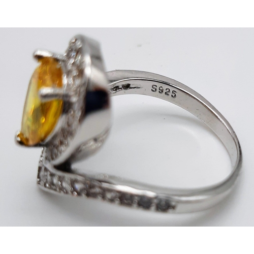 176 - A white metal ring and earrings set with yellow topaz and white sapphires. Ring size: N, presented i... 