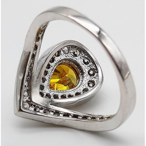 176 - A white metal ring and earrings set with yellow topaz and white sapphires. Ring size: N, presented i... 