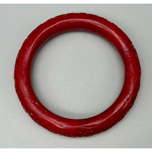 190 - A Chinese, antique, hand carved, dark red jade bangle. Inner diameter: 63 mm, weight: 84 g.