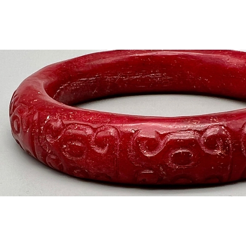 190 - A Chinese, antique, hand carved, dark red jade bangle. Inner diameter: 63 mm, weight: 84 g.