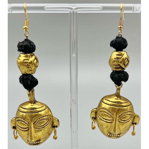 162 - An original, West African, (Benin style) necklace and earrings set with gilded metal masks. It is be... 