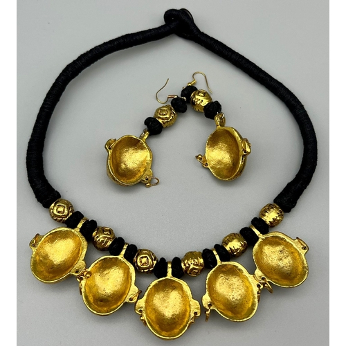 162 - An original, West African, (Benin style) necklace and earrings set with gilded metal masks. It is be... 