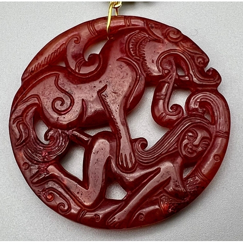 204 - An unusual, Chinese, reddish brown jade amulet depicting a scene from the ancient myth The Beauty an... 