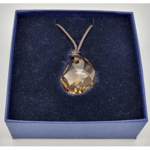 512 - A Swarovski Amber Glass Crystal Pendant on a Thin Rope Necklace. As new, in original box with certif... 