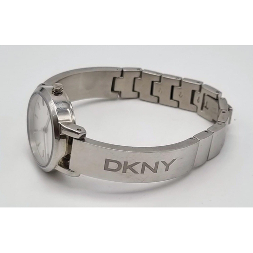 419 - A DKNY Ladies Quartz Dress Watch. Stainless steel bracelet and case - 23cm. white dial, in working o... 