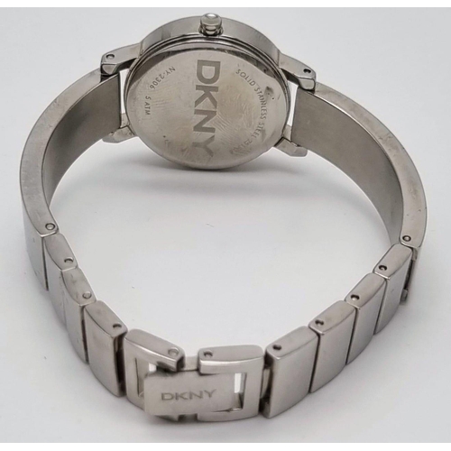 419 - A DKNY Ladies Quartz Dress Watch. Stainless steel bracelet and case - 23cm. white dial, in working o... 