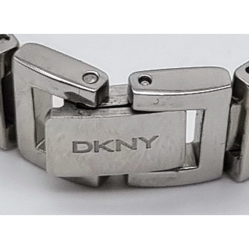 419 - A DKNY Ladies Quartz Dress Watch. Stainless steel bracelet and case - 23cm. white dial, in working o... 