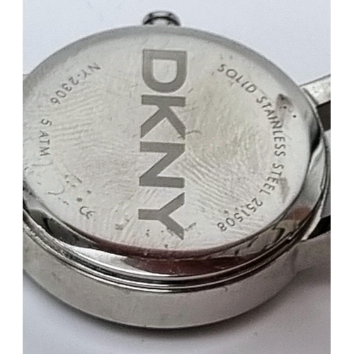 419 - A DKNY Ladies Quartz Dress Watch. Stainless steel bracelet and case - 23cm. white dial, in working o... 