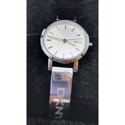 419 - A DKNY Ladies Quartz Dress Watch. Stainless steel bracelet and case - 23cm. white dial, in working o... 