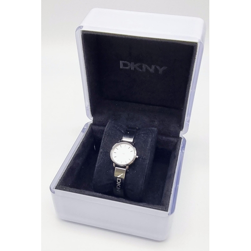 419 - A DKNY Ladies Quartz Dress Watch. Stainless steel bracelet and case - 23cm. white dial, in working o... 