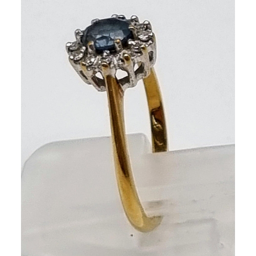 509 - A 9K Yellow Gold Topaz and Diamond Ring. Centre blue topaz surrounded by a halo of diamonds. Size L.... 