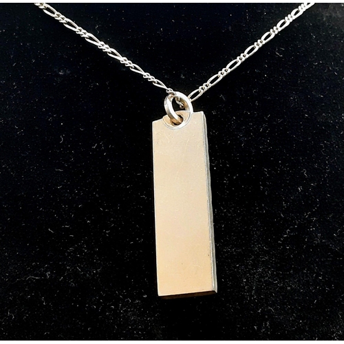 680 - A Sterling Silver Ingot Pendant - On a sterling silver necklace. Hallmarks for Birmingham 1978. 4 an... 