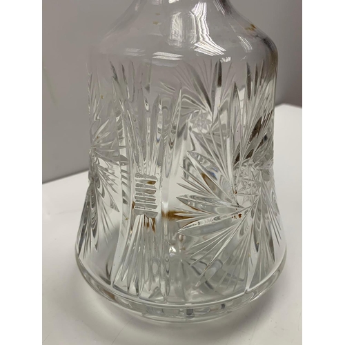 1029 - Antique cut glass decanter with wide base, star spiral design on side. Width 13.5cm, Height 30cm.